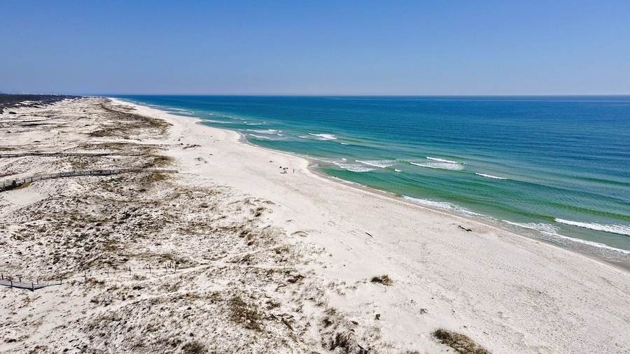 Wide aerial view of the Gulf shoreline and dunes